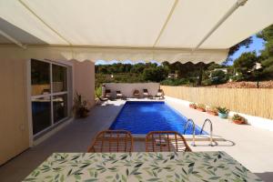 a swimming pool in a house with a table and chairs at Family friendly house with a swimming pool Rukavac, Vis - 24700 in Vis