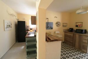 a kitchen with a black refrigerator and a counter at Family friendly house with a swimming pool Rukavac, Vis - 24700 in Vis