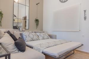 a couch with pillows on it in a living room at The Neo-Classic Loft in Rhodes Town +31 photos