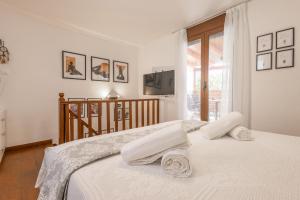 a white bedroom with a bed and a window at The Neo-Classic Loft in Rhodes Town