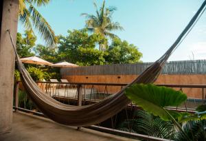 a hammock on a balcony of a resort at Casa Marisa in Puerto Escondido