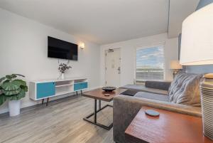 a living room with a couch and a table at Stunning Ocean Views, Elegant 1-bdr Condo 4th FL Boardwalk Beach Resort in Myrtle Beach