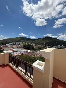 a balcony with a view of a city and mountains at Paseo de la Fe in Salta