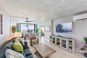 a living room with a couch and a table at Lauloa 103 in Wailuku