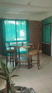 a dining room with a table and two chairs at El Arbol in Eldorado