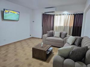 a living room with two couches and a coffee table at Amplio y cómodo apto Diagonal a URBE in Maracaibo