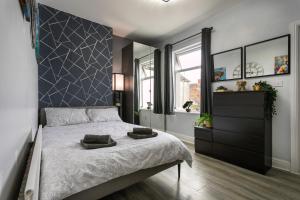 a bedroom with a large bed with two pillows on it at The Regent - Stylish Luxury Leicester Studio near City Centre! in Leicester