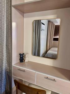 a bathroom with a dresser and a mirror at Tey Spot in Iloilo City +4 photos