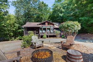 a log cabin with two chairs and a porch at Time Out in Blue Ridge