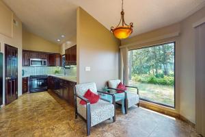 a kitchen with two chairs and a table and a window at 11347 Marina Dr in Berlin