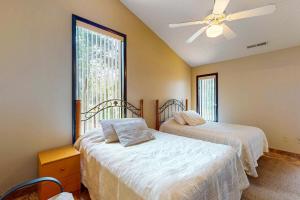 a bedroom with two beds and a ceiling fan at 11347 Marina Dr in Berlin
