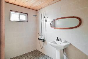 a bathroom with a sink and a mirror at Jejuya Pyoseon in Seogwipo +52 photos