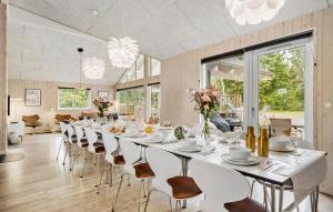 a long dining room with a long table and chairs at Holiday Home Frederiksværk With Fireplace 10 in Frederiksværk
