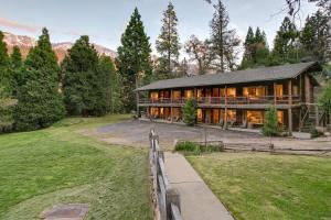 a home in the mountains with a fence at Mountain Nook CN Lodge #4 in Ponderosa