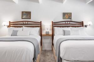 two twin beds in a room with two lamps at Camp Nelson Lodge Room 2 in Ponderosa
