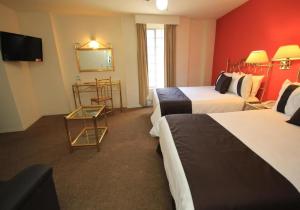 Postel nebo postele na pokoji v ubytování Hotel Argento Zacatecas