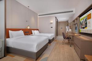 Postel nebo postele na pokoji v ubytování Home2 Suite by Hilton Nantong Vientiane City
