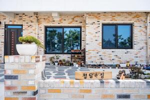 a brick building with a sign in front of it at Uljin Jeongdam-eun Ocean View Pension in Uljin