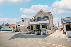 a stone house is on the side of a street at Uljin Jeongdam-eun Ocean View Pension in Uljin +8 photos