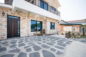 a large brick building with a large patio at Uljin Jeongdam-eun Ocean View Pension in Uljin
