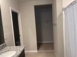 a bathroom with a shower and a sink and a mirror at Parrish villa in Parrish