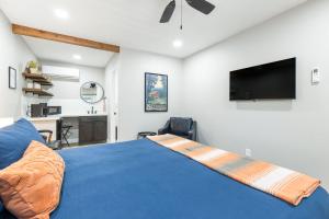 a bedroom with a blue bed and a flat screen tv at The Tokopah Sequoia Motel RM 1 in Three Rivers