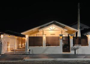a white house with lights on it at night at Cantinho de canela in Canela