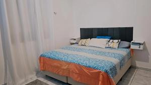a bedroom with a large bed in a room at Chácara Cop 30 in Marituba