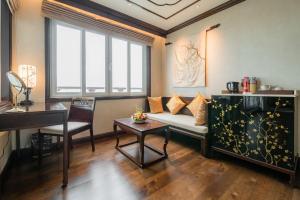 a living room with a couch and a table at Heritage Line Ginger Cruise - Halong Bay & Lan Ha Bay in Ha Long