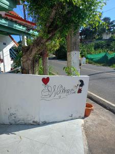 a sign on a wall on the side of a street at Waiting you come in Phuket Town +1 photo