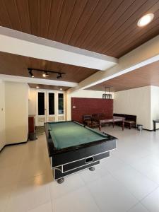 a large room with a pool table in it at Little Creek Lodge in Malang