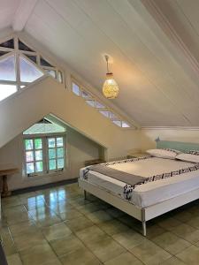 a bedroom with two beds in a attic at Little Creek Lodge in Malang +22 photos