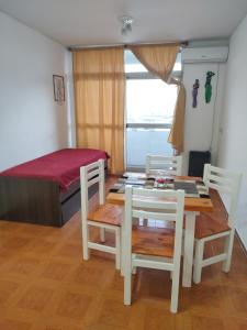a room with a table and chairs and a bed at Vista sur in Buenos Aires