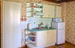 a small kitchen with a sink and a refrigerator at Patarei Apartment in Tallinn
