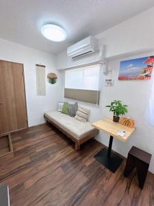 a living room with a couch and a table at Katsu Hotel 新今宮 in Osaka +221 photos