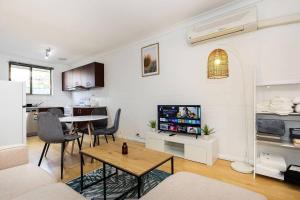 a living room with a table and a tv in it at *Charming 2BR Retreat in Heart of Southern Bliss in Albury