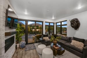 a living room with a couch and a fireplace at 4-Season Modern Mountain Penthouse with Private Hot Tub & Scenic Views in Silverthorne