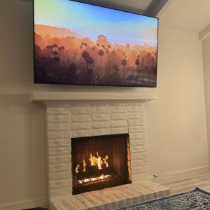 a fireplace with a flat screen tv above it at Montecito-Splendide beachside retreat in Montecito