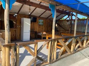 a refrigerator in the middle of a wooden house at Casa Flavia in Mahmudia