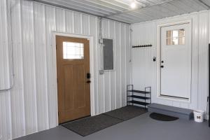 an empty room with a door and a window at Reedsong Cottage in Hillsdale