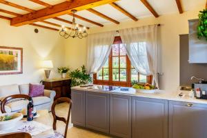 a kitchen with a table and a counter top at Private Villa Among Pine Trees And Lavender in Marina di Grosseto