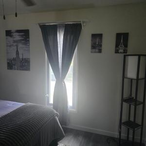 a bedroom with a bed and a window at Peace and tranquility in Davenport