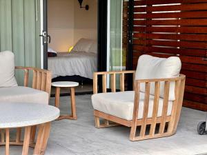 a room with chairs and a bed and a table at The Eco Shed - Private Riverfront Getaway - Close to Town - Pet Friendly in Bellingen