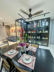 a dining room with a table with glasses of wine at Paradigm MarvelClassic JB Platino 3BR 10PAX in Johor Bahru