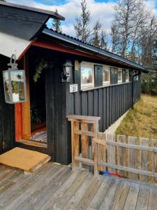 a building with a porch and a wooden deck at Traditional Family Cabin Near Rabalen in Bagn