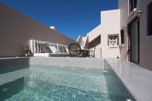 a swimming pool in the middle of a house at Antique Mansion in Oia