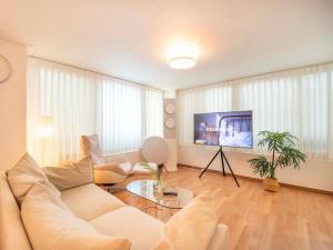 a living room with a white couch and a tv at Stay Cheonglim 靑林 in Seoul