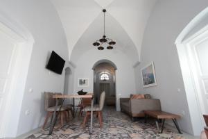 a living room with a table and a couch at Antique Mansion in Oia