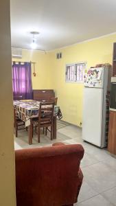 a kitchen and dining room with a table and a refrigerator at Casita cómoda y de confianza in San Fernando del Valle de Catamarca