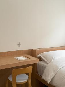 a bedroom with a desk with a bed and a chair at arrdep in Seoul
